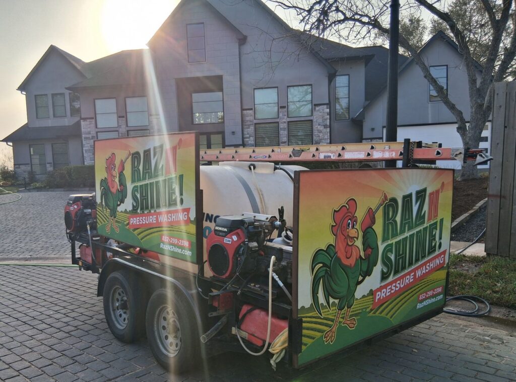 Raz N' Shine professional pressure washing trailer parked in front of a residential home.